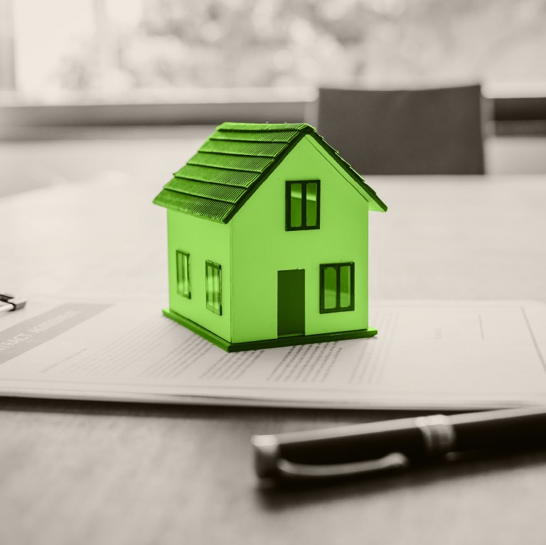 green house on an application on a clipboard with a pen next to it