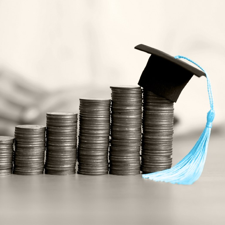 graduate cap on money