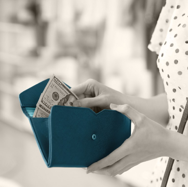 open wallet with hand inserting money