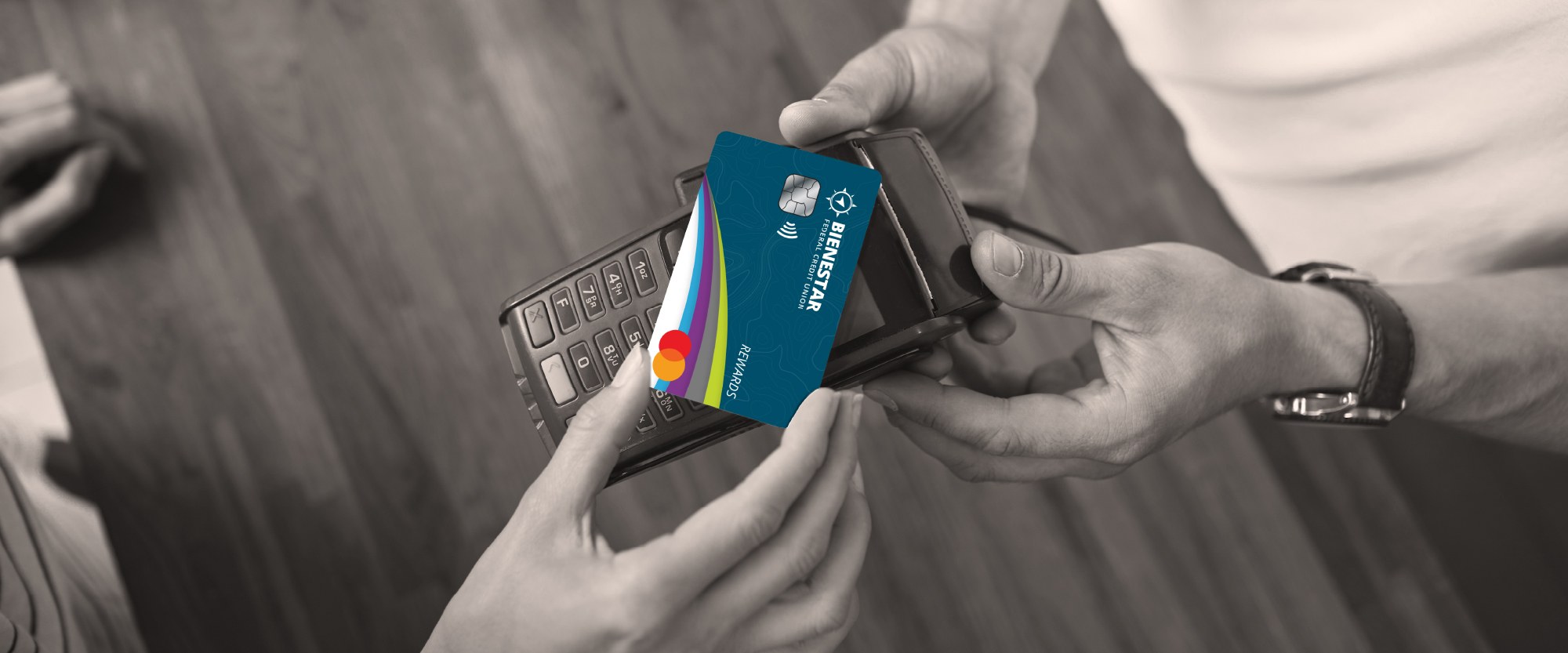 hand holding card that is tapped onto a device to pay for items