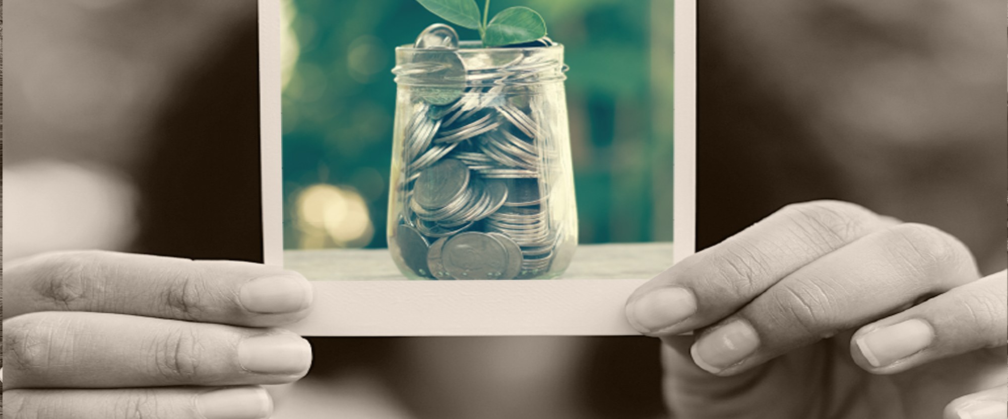 Person holding a photo of a jar of quarters