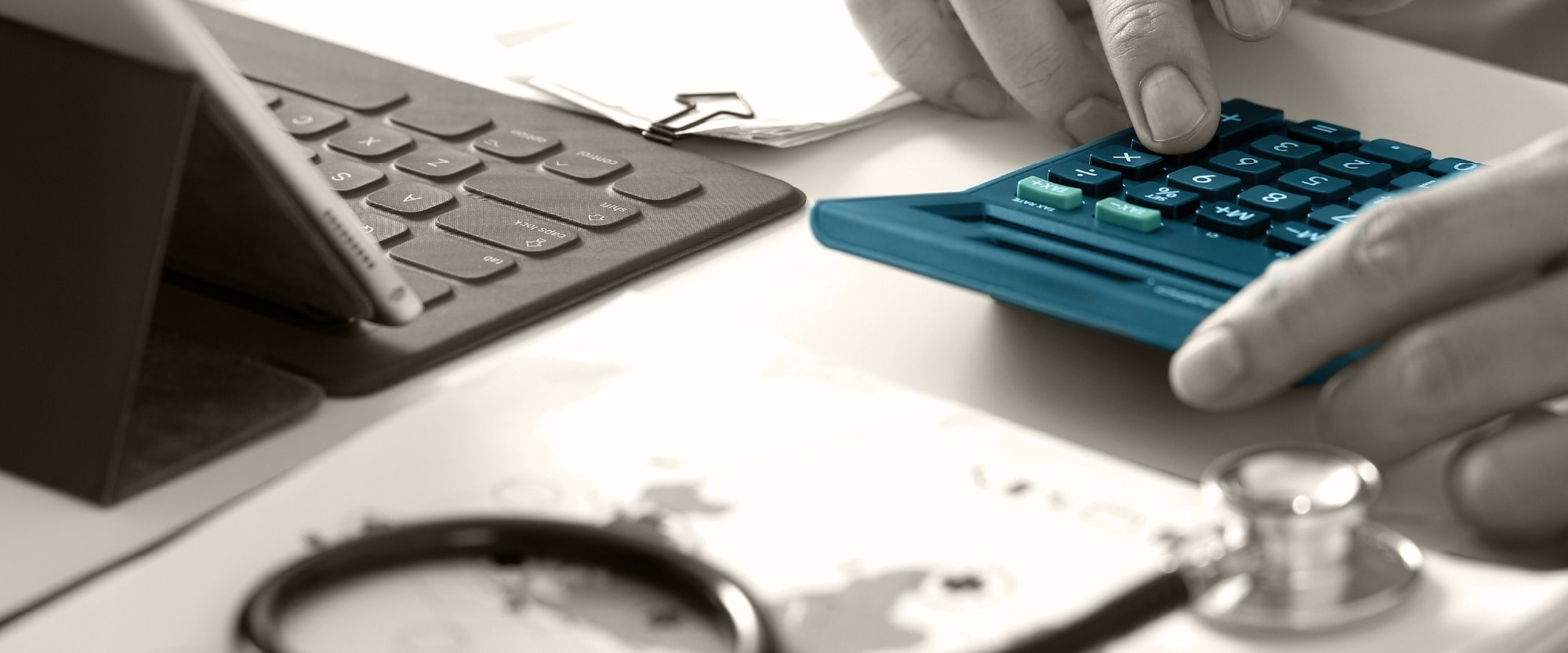 desk with laptop and blue calculator