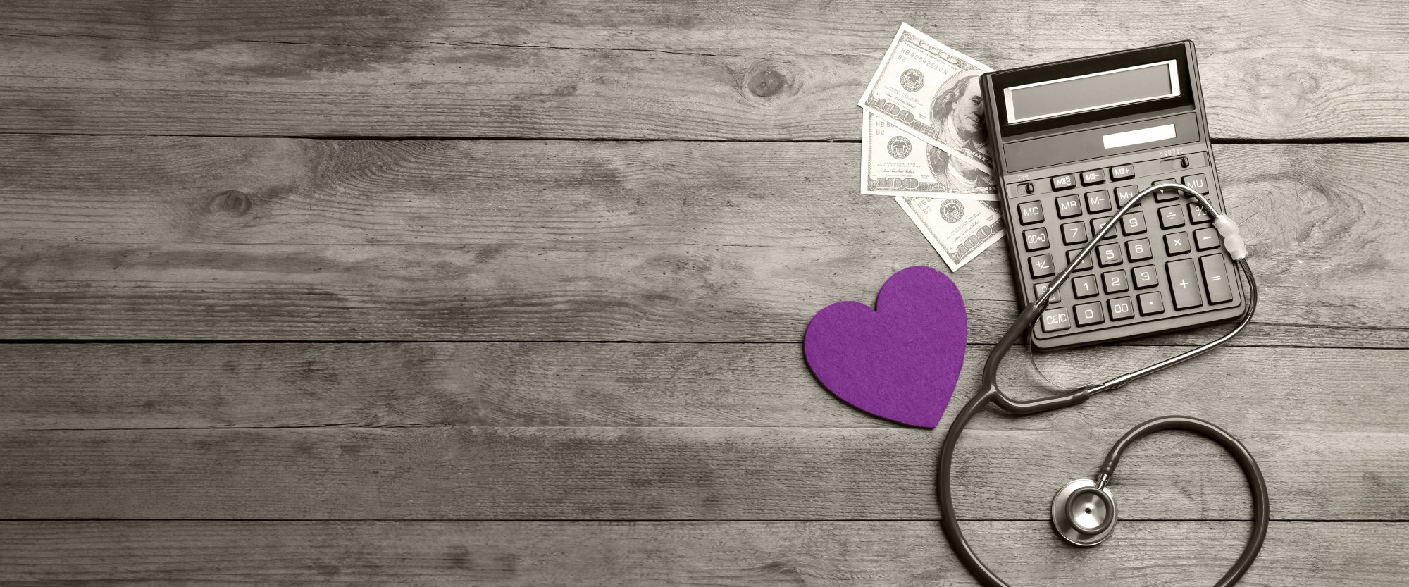 teal heart with stethescope next to calculator