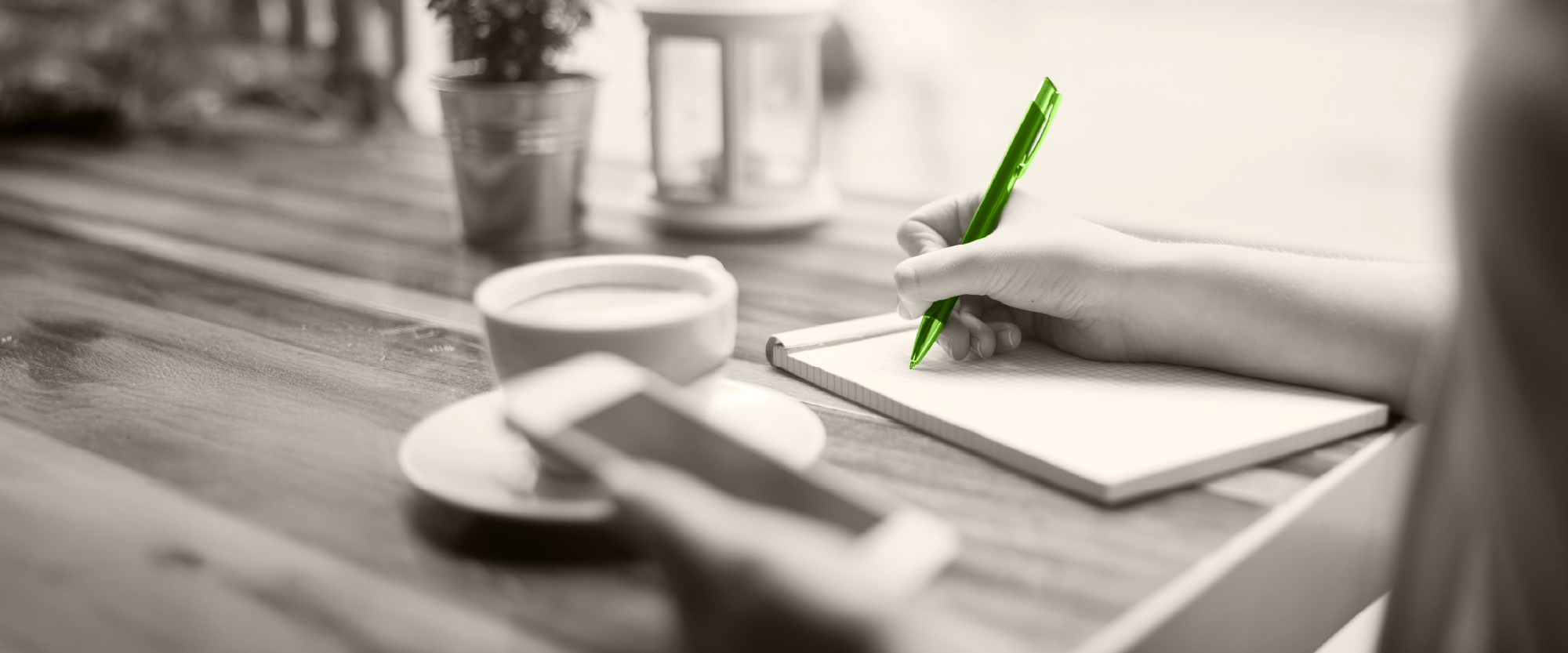 hand writing on paper with a green pen