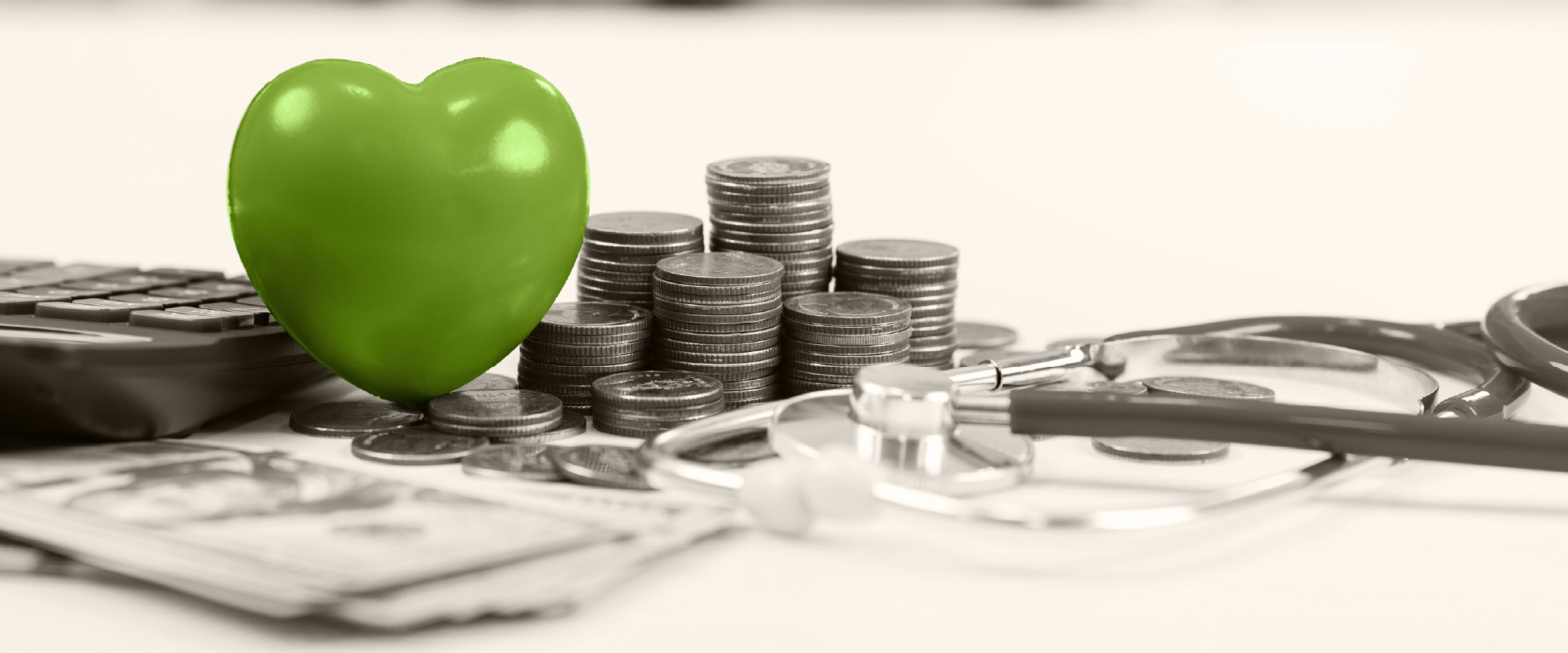 green heart stethescope over a calculator