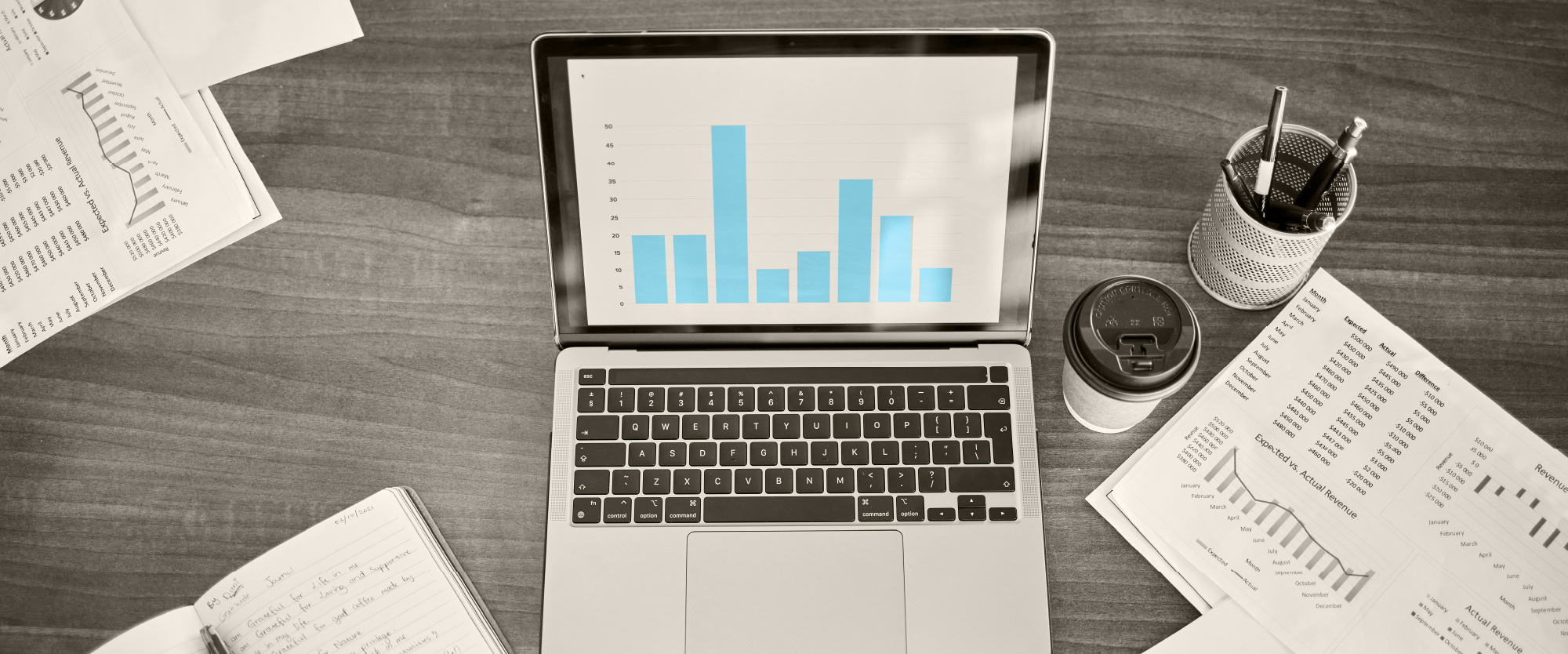 open laptop with bright blue budgeting charts and graphs